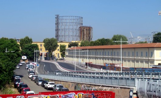 The view on exiting Garbatella Metro Stop. Via Ostiense is in front, where the yellow building is. Il Gasometro is behind it. Centrale Montemartini is just to the left.