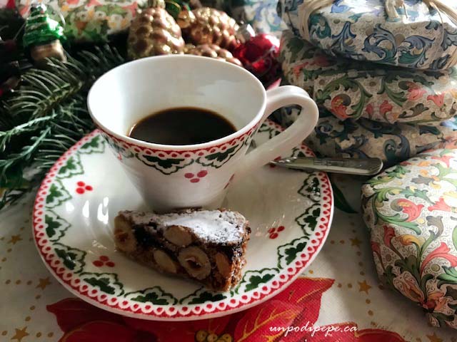 Panforte di Siena wedge with espresso and Christmas ornaments